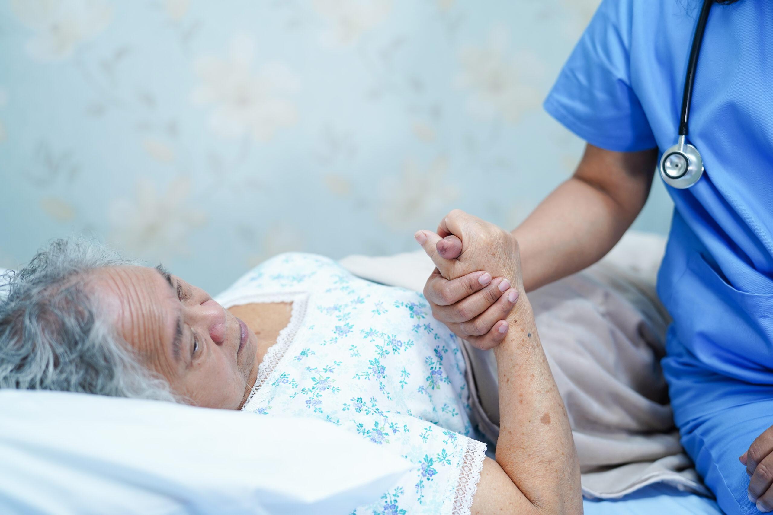 hospice nurse helping patient with end of life loose bowels