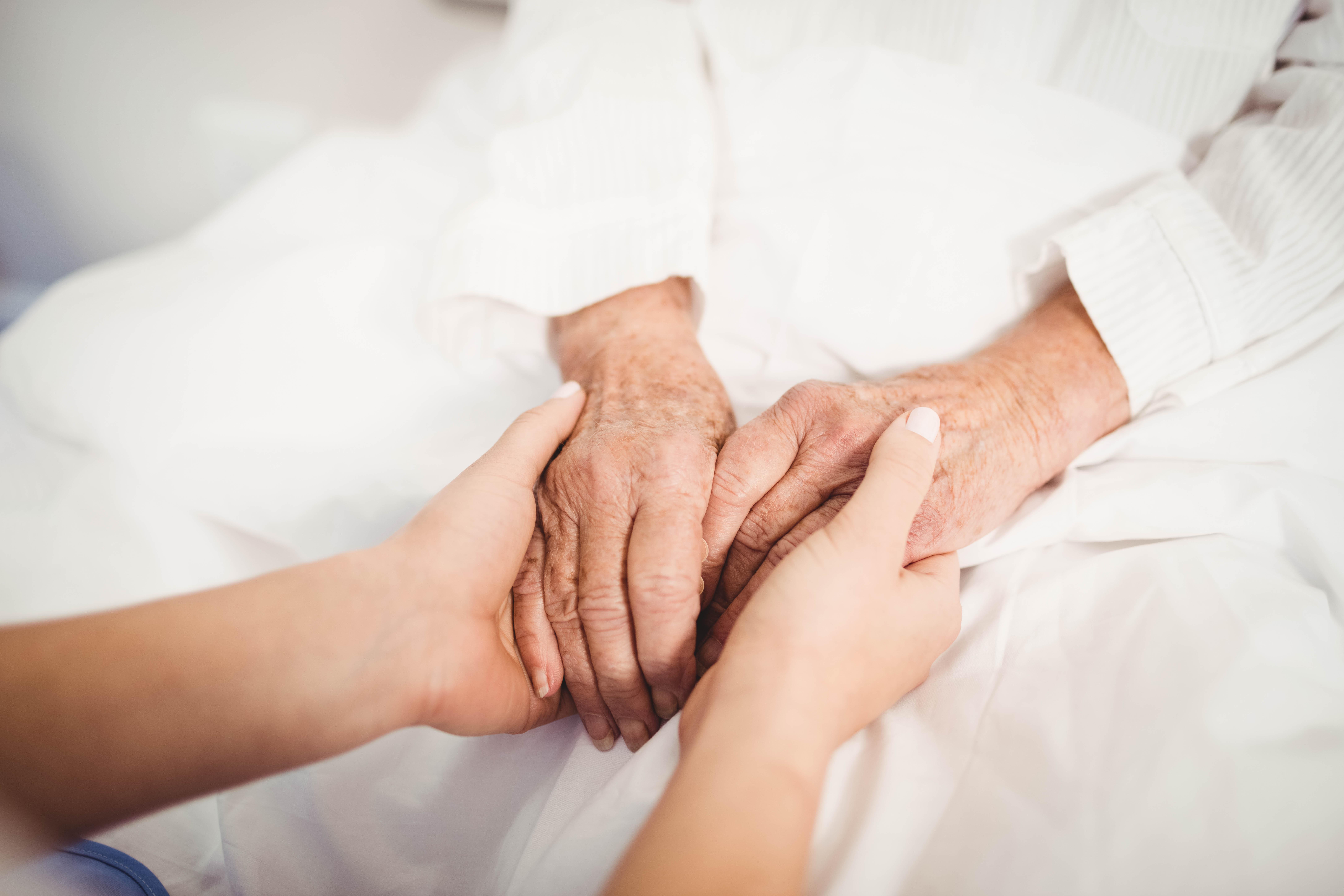 hospice nurse helping patient with end of life diarrhea